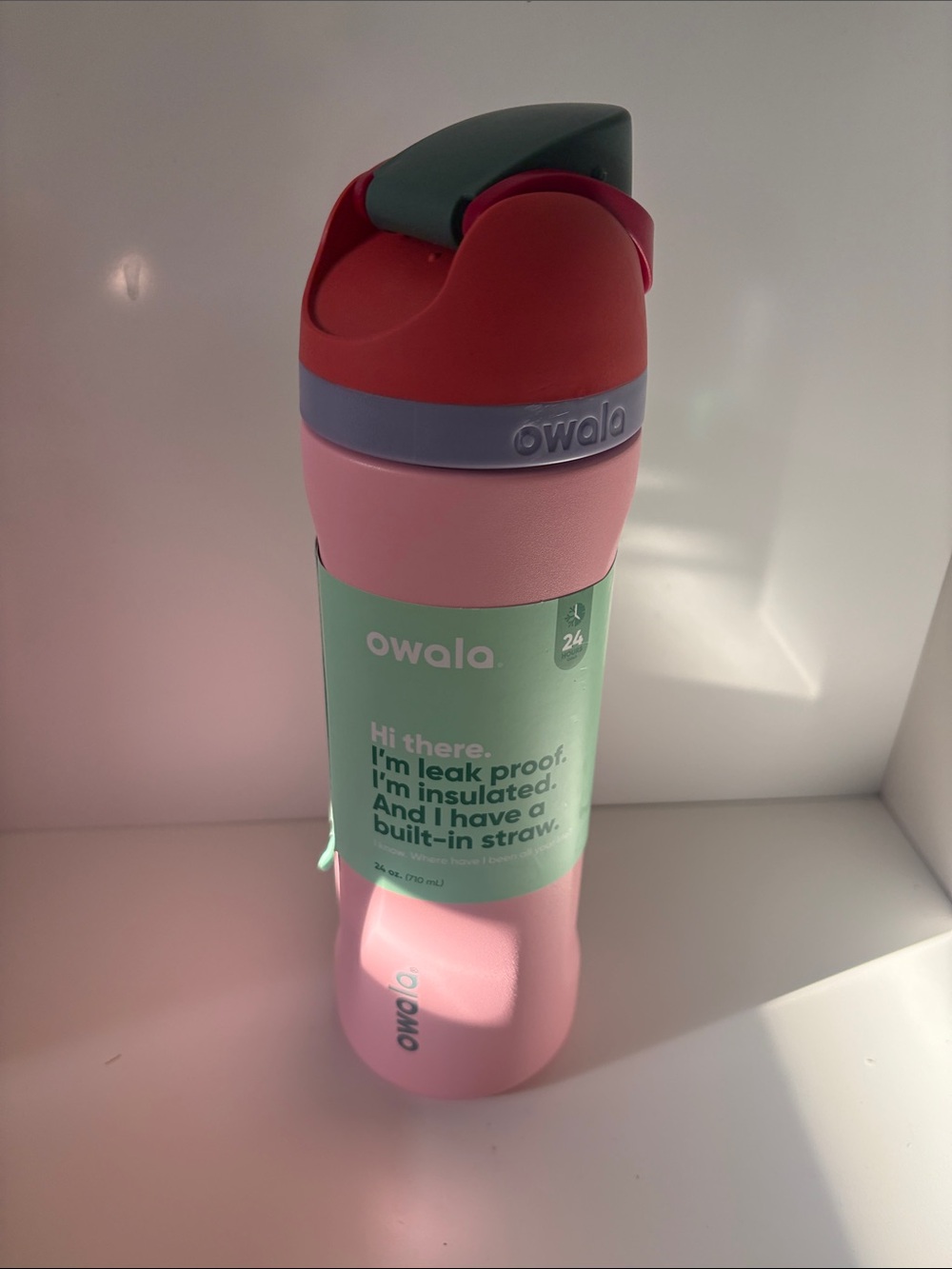 Owala Insulated Pink Water Bottle with Red and Teal Lid